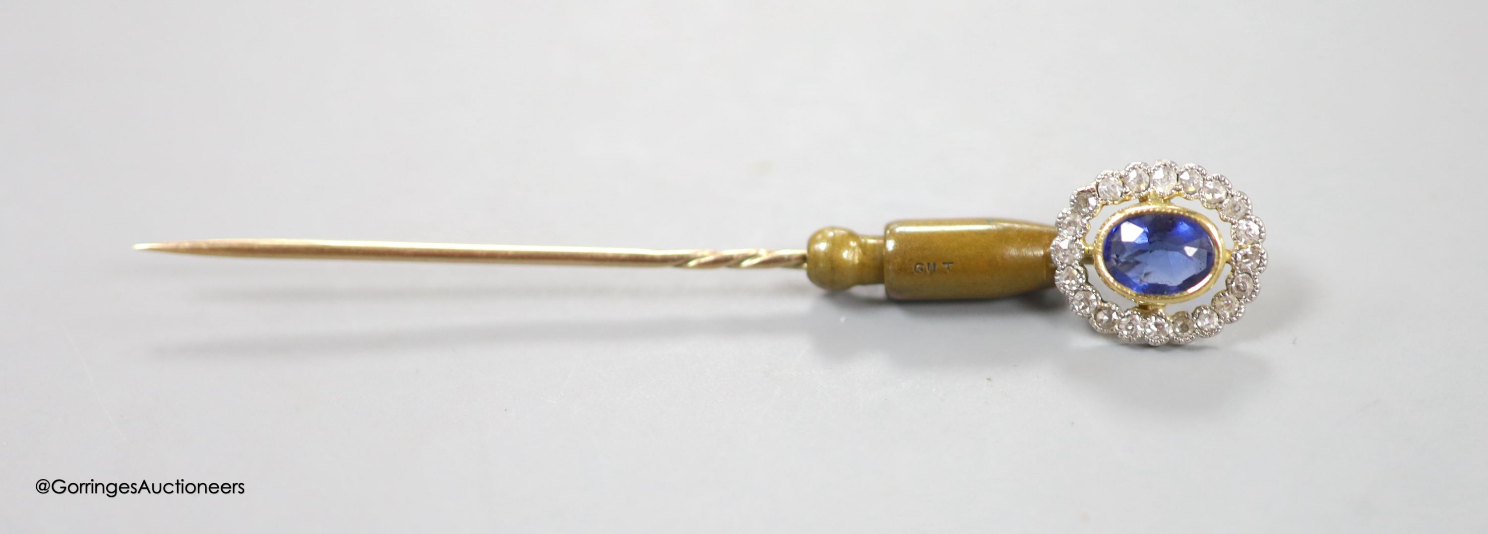 An early 20th century yellow metal, sapphire and diamond set oval cluster stick pin, 72mm, gross weight 3.9 grams